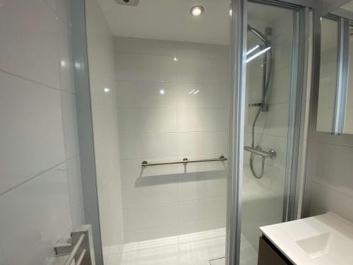 a shower with a glass door in a bathroom at Appart. 2 pièces, 6 couchages, terrasse, garage, Le Grand-Bornand - FR-1-241-27 in Le Grand-Bornand