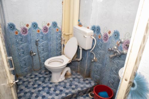 a bathroom with a toilet and a shower at Ganesh Residency in Cuttack