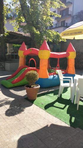 a childs play equipment with a playground at Hotel Moderno in Aritzo