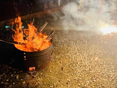 a pot of fire on a street with smoke at Aden Valley Tent Stay , kanthalloor in Kanthalloor