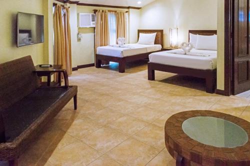 a hotel room with two beds and a table at Sheridan Villas Boracay in Boracay