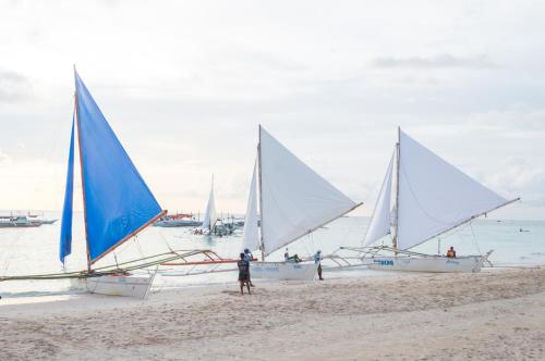 a group of sailboats on a sandy beach at Sheridan Villas Boracay in Boracay