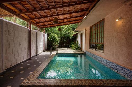 a swimming pool in the middle of a house at Avontade Suites in Anjuna