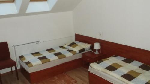 Кровать или кровати в номере Penzión Lindava