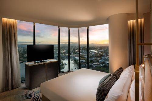 a hotel room with a bed and a television at Dorsett Gold Coast in Gold Coast