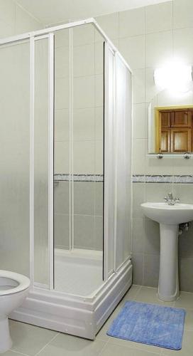 a bathroom with a shower and a toilet and a sink at Boncuklu Otel in Fethiye