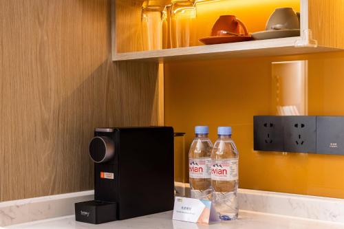 two bottles of water are sitting on top of a kitchen counter at Home2 Suites by Hilton Guiyang Nanming Jiyuan in Guiyang
