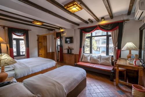 Postel nebo postele na pokoji v ubytování Hotel Ganesh Himal