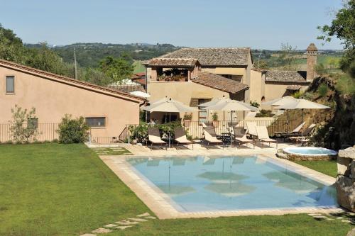 a large swimming pool in front of a house at Molino Della Lodola in Rapolano Terme