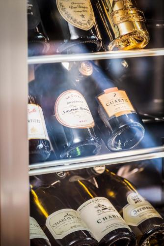 a refrigerator filled with lots of bottles of wine at Hotel Stein Collection in Timişoara