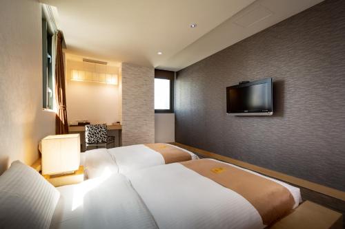 מיטה או מיטות בחדר ב-Byeyer Hotel