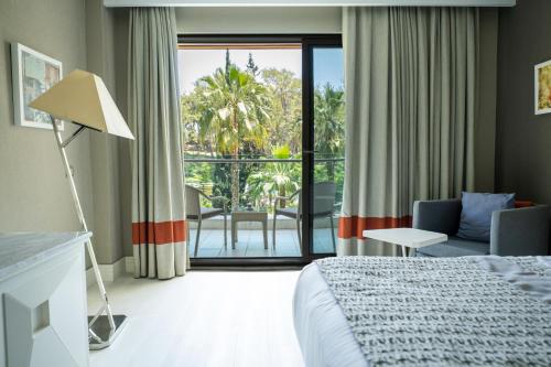 a hotel room with a bed and a large window at Wome Prime Hotel - Halal All Inclusive in Alanya