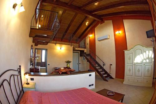 a bedroom with a bed and a staircase in a room at Hotel del Rio Srl - RISTORANTE e Azienda agricola in Casinalbo