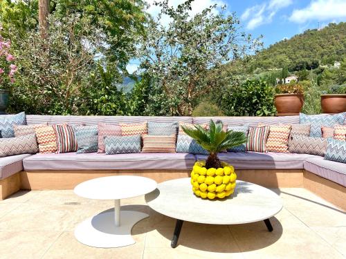 a couch with a pineapple sitting on a patio at Le Gabriel in Claviers