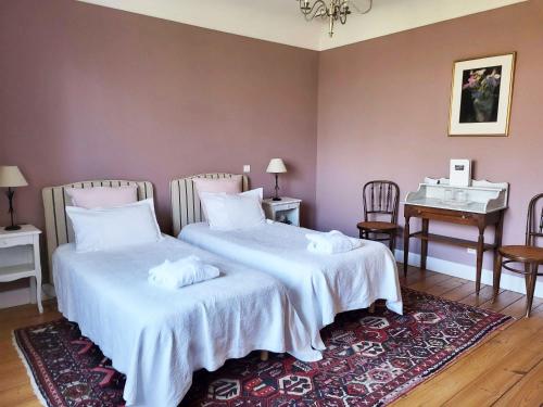 a bedroom with two beds and a desk and a piano at Clos Mirabel Manor - B&B in Jurançon