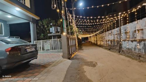 a car parked in front of a building with lights at Coorg ASHOK PALACE in Madikeri