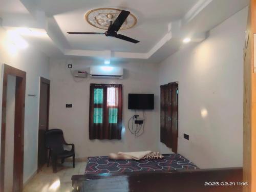 een slaapkamer met een bed en een plafondventilator bij Le Grace Eden in Madurai