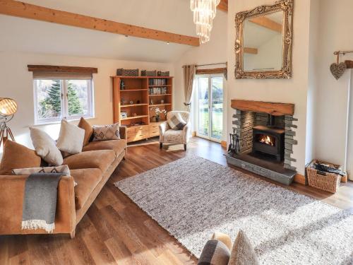 a living room with a couch and a fireplace at Haystacks in Troutbeck