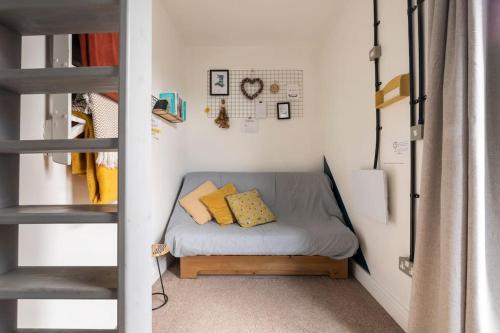 a small bed in a small room next to a ladder at Bethel Nook, a cosy stay in the Welsh Valleys in Hirwaun