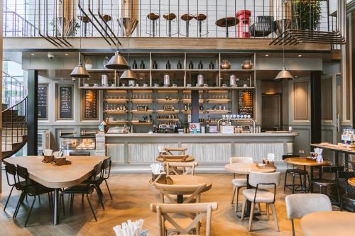 a restaurant with tables and chairs and a bar at Conrad Shanghai in Shanghai