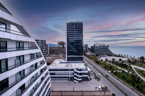 a view of a city with a tall building at The Grandeur Hotel in Batumi