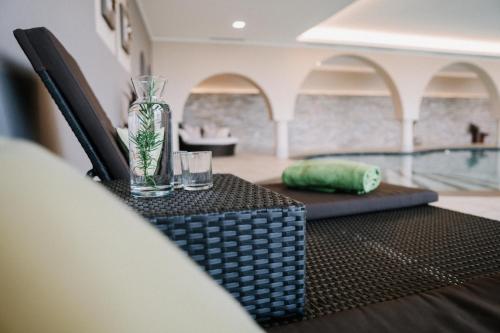 a table with a glass vase on top of it at Hotel Garni Katnau in Schenna