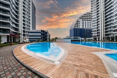 a swimming pool in a city with tall buildings at The Grandeur Hotel in Batumi