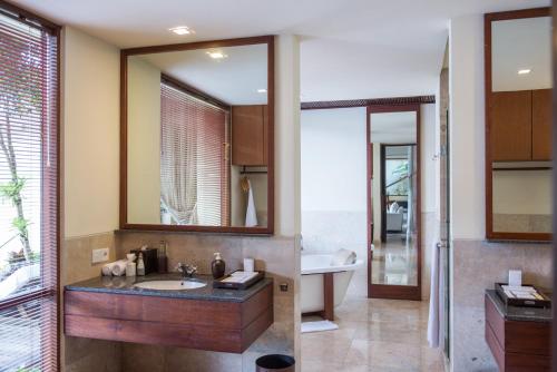 a bathroom with a sink and a tub at Komaneka at Bisma Ubud in Ubud