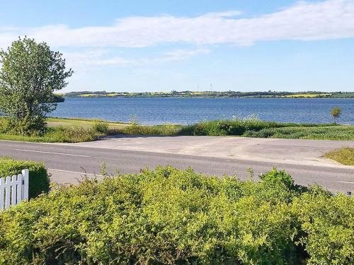 an empty road next to a body of water at 5 person holiday home in Sydals in Trænge