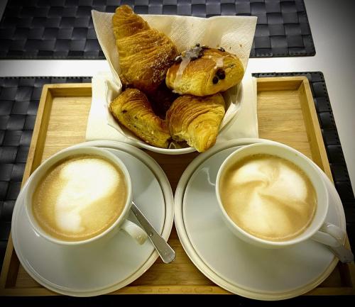 two cups of coffee and pastries on a tray at Le Vie del Vaticano in Rome
