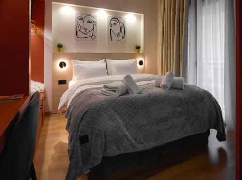 a bedroom with a large bed with two pillows on it at Plane Tree Luxury Suites in Ioannina