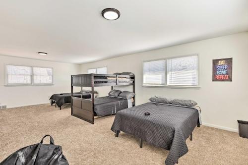 a bedroom with two beds and a bunk bed at Pet-Friendly Wichita Home with Deck, Near Dtwn in Wichita