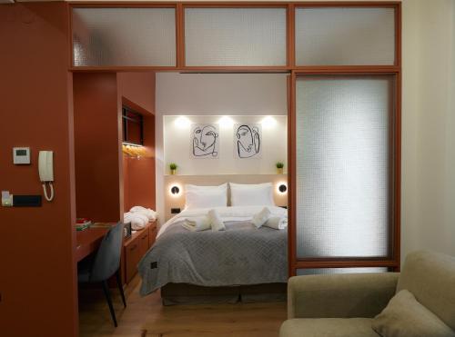 a bedroom with a bed and a desk and a chair at Plane Tree Luxury Suites in Ioannina