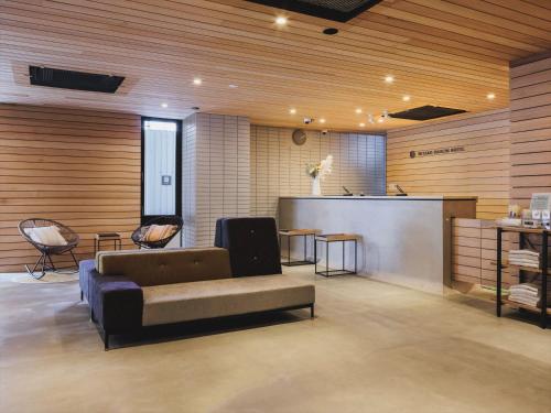 a living room with a couch and a table at Miyako Daiichi Hotel in Miyako Island