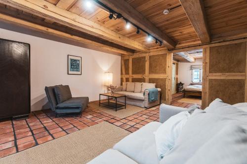 a living room with a couch and a tv at Zagroda Swołowo in Słupsk