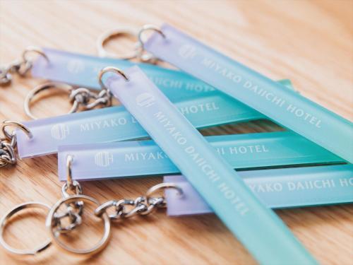 a group of four pairs of keys on a table at Miyako Daiichi Hotel in Miyako Island