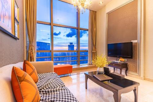 a living room with a couch and a large window at WAIFIDEN Guangzhou Grand View Golden Palace Apartment in Guangzhou