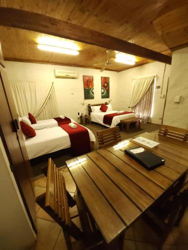 Ένα ή περισσότερα κρεβάτια σε δωμάτιο στο Rusplek Guesthouse and Conference Centre