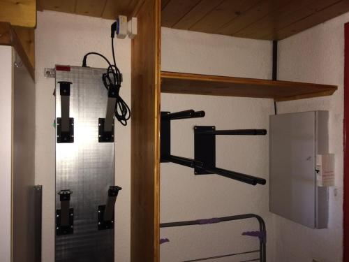 a bathroom with a shower with black shelves on the wall at Arcs 1800 Duplex rénové 5 pers au pied des pistes calme location à la semaine seulement in Arc 1800