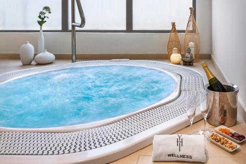 a hot tub in a bathroom with a sink at Melia Sierra Nevada in Sierra Nevada