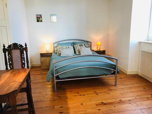 a bedroom with a bed and a wooden floor at Gîte Léonline sur les hauteurs de Masevaux -au pied des Vosges in Masevaux