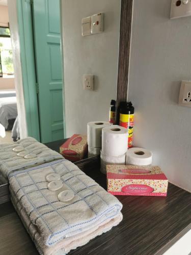 a table with a towel and toiletries on it at Cheers Garden Chalet in Kampung Tekek