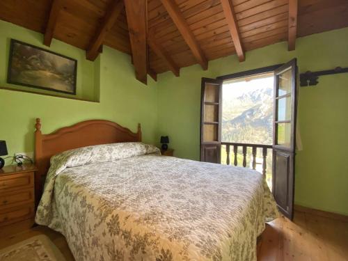 a bedroom with a bed and a large window at Casa El Marizal 1 Arriondas in Arriondas