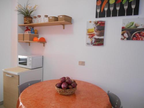 a kitchen with a table with a bowl of fruit on it at BlueMind in Tropea