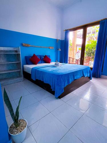 a blue bedroom with a bed and a window at Pandan Wangi in Nusa Lembongan
