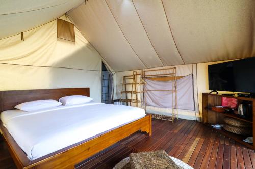 a bedroom with a bed in a tent at Alinson Sunset Hill in Bogor