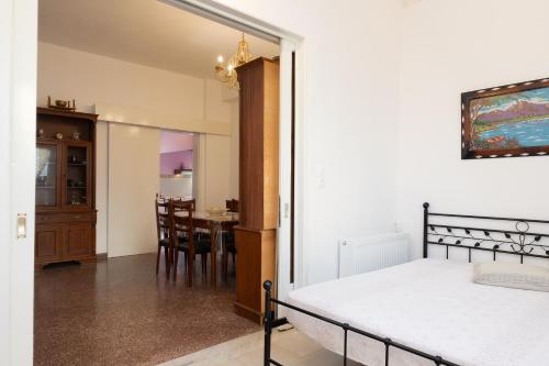 a bedroom with a bed and a dining room with a table at Golden Seaside House number 2 in Eantio