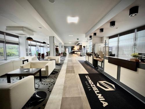 a lobby of a hotel with couches and tables at Hotel Szyndzielnia Eco in Bielsko-Biała