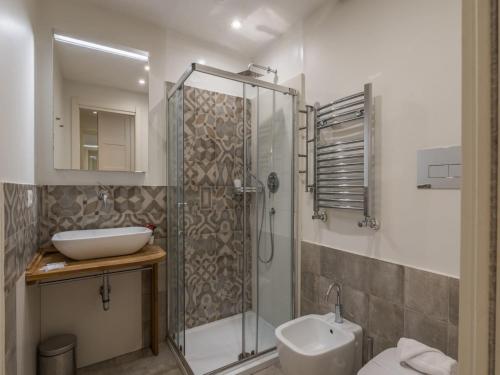 a bathroom with a shower and a sink and a toilet at The Best Rent - Elegant flat near Colosseum in Rome