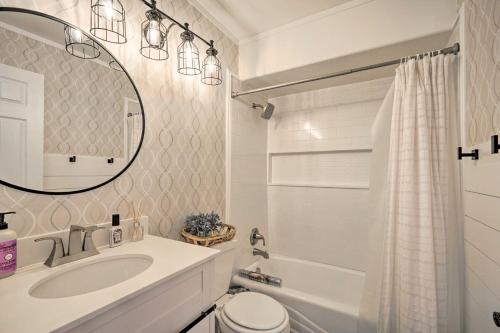 een badkamer met een wastafel, een toilet en een spiegel bij Woods Cross Vacation Rental with Hot Tub! in Woods Cross
